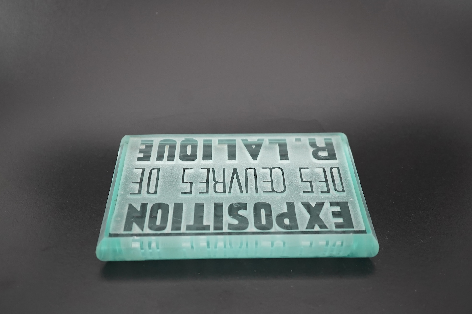 Lalique: A glass advertising plaque 'EXPOSITION DES ŒUVRES DE R.LALIQUE'